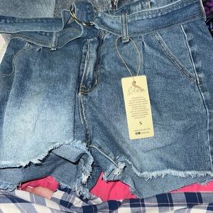 Cute denim shorts with belt. Never been worn. Still has tags. Too big on me.